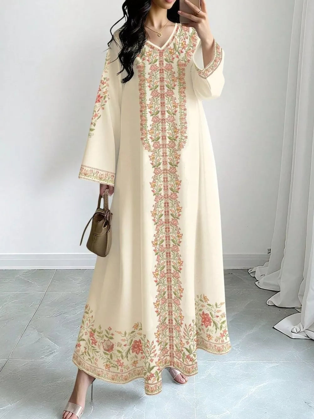 Elegant cream floral maxi dress with V-neck and long sleeves.