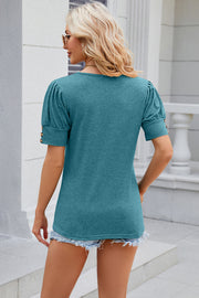 Turquoise tee with gathered sleeves and gold button details
