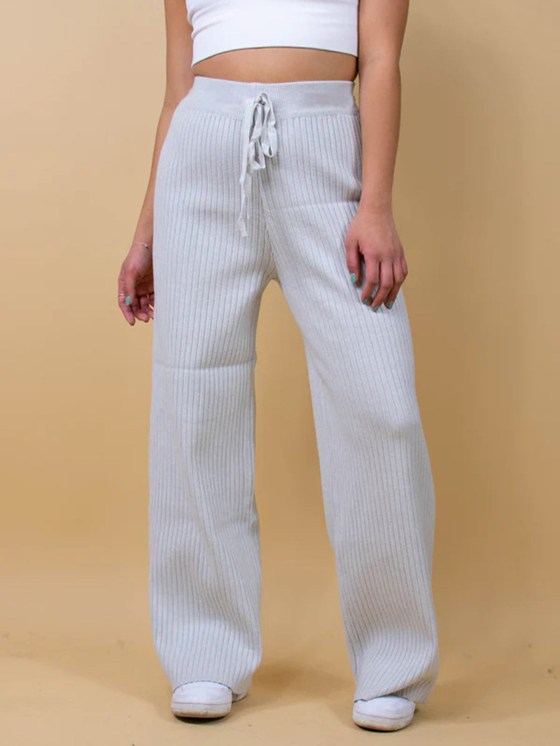 Luxe ribbed knit palazzo trousers in light gray with a drawstring waist.