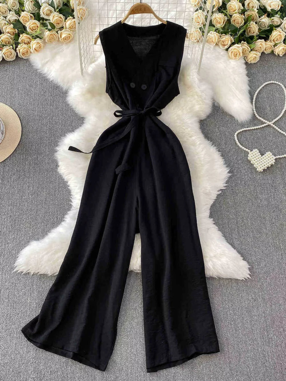 Black V-neck wide leg jumpsuit with tie belt and button details