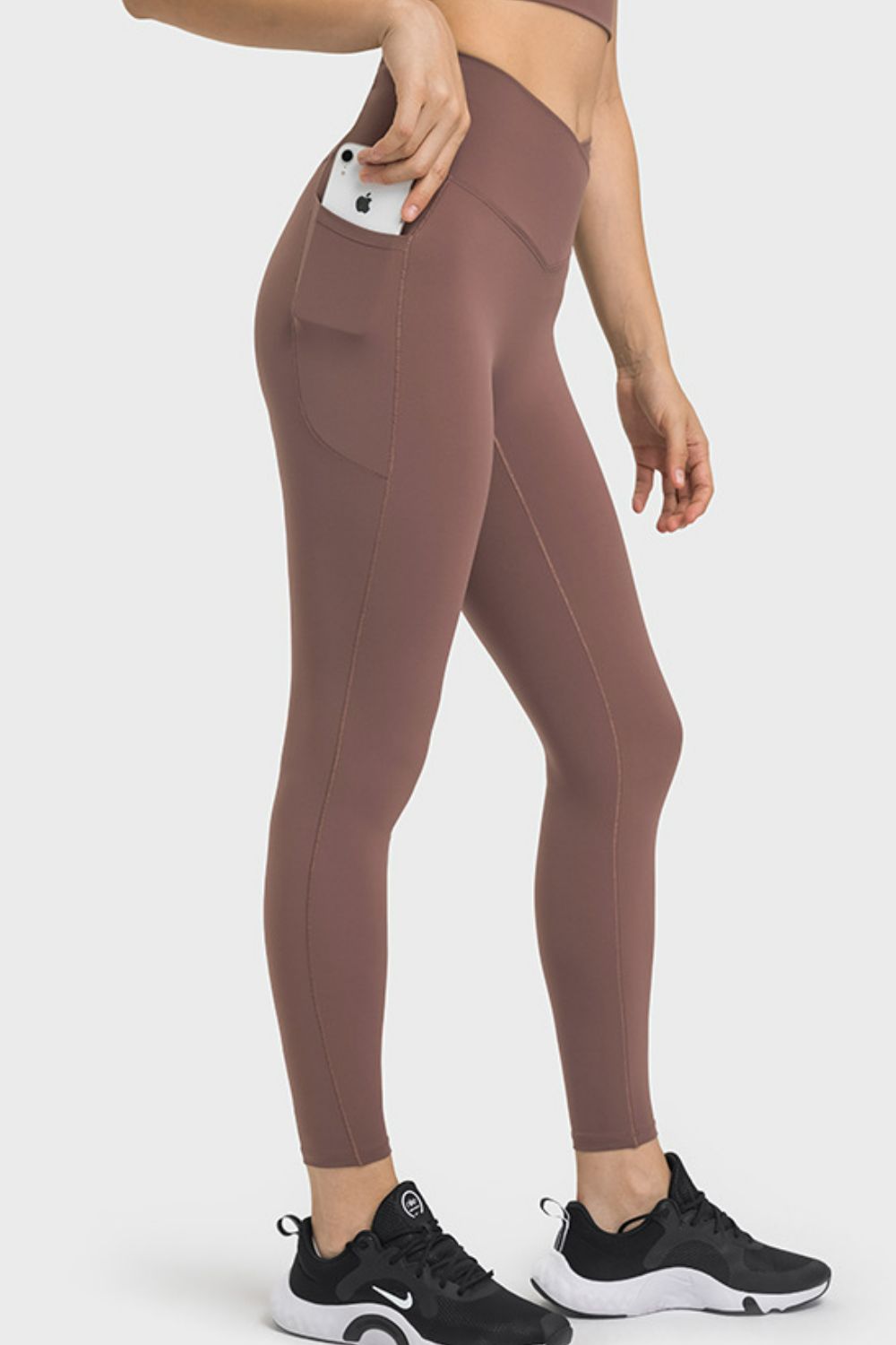 Brown performance leggings with pockets, phone in pocket