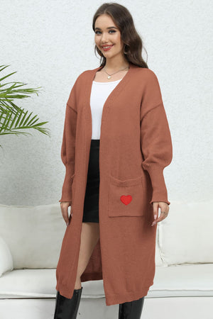 Brown long cardigan with balloon sleeves and a red heart pocket detail.