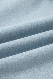 Light wash denim jeans with a textured weave and soft folds.