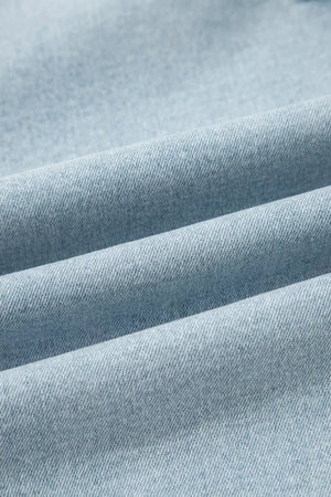 Light wash denim jeans with a textured weave and soft folds.
