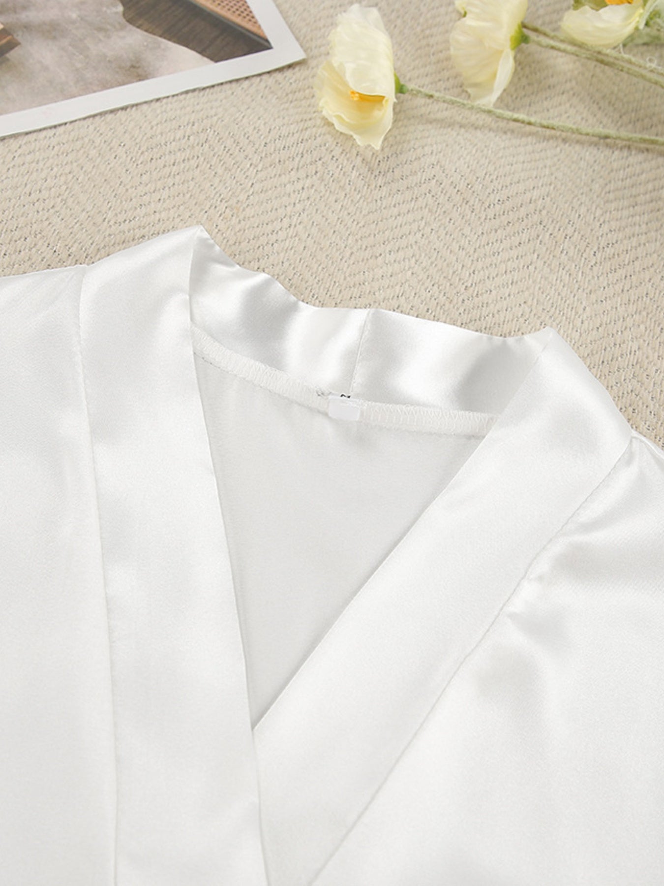 White satin robe with lace trim detail and V-neckline