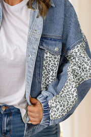 Denim jacket with leopard print panels and elastic cuffs.
