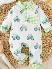 White baby one-piece with green tractor print and green gingham trim collar, pocket, and cuffs.