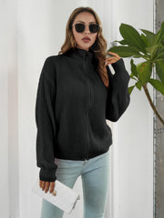 Black ribbed knit zip-up sweater with mock neck and long sleeves.