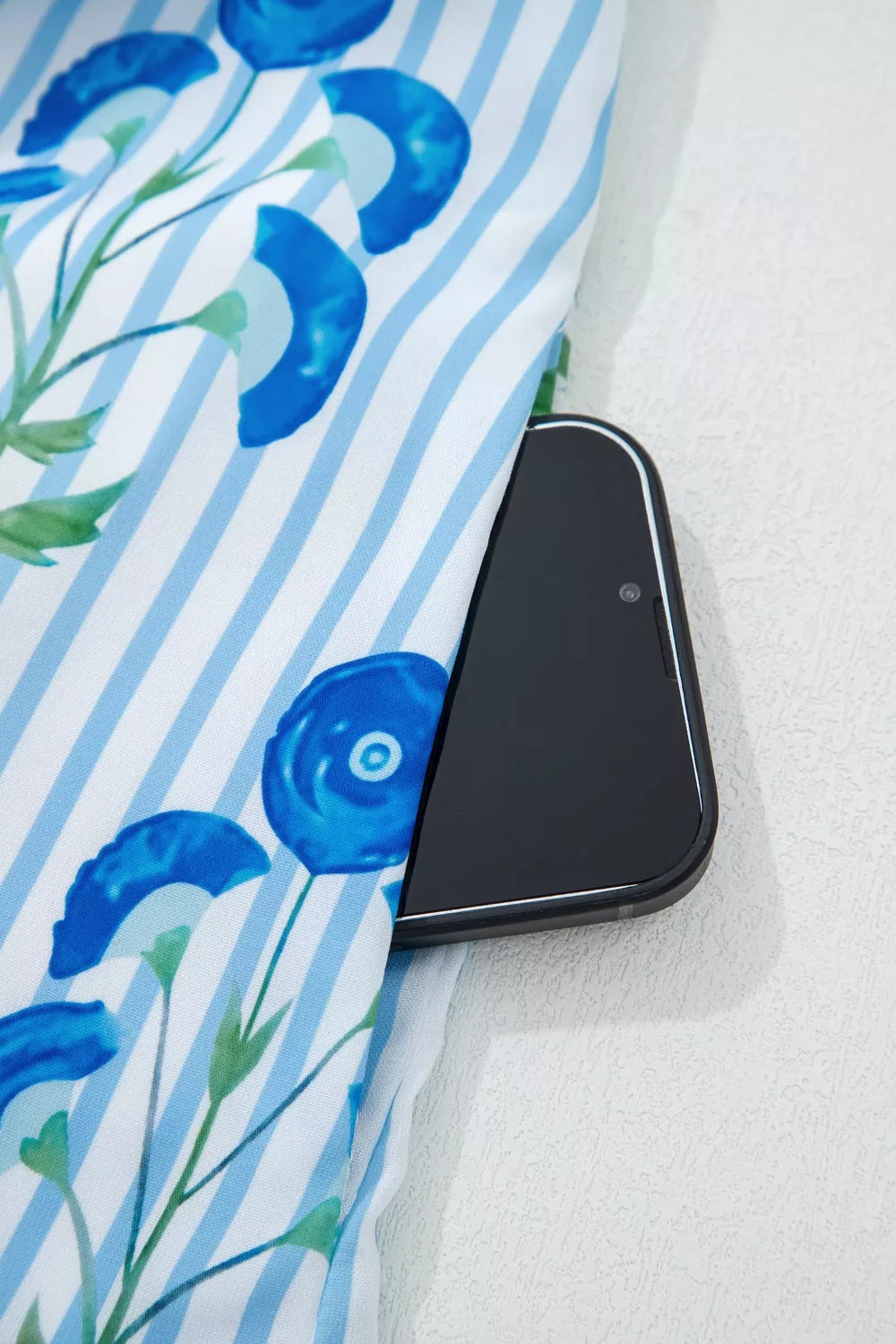 Floral stripe mini dress with blue flowers, showing a phone pocket detail.