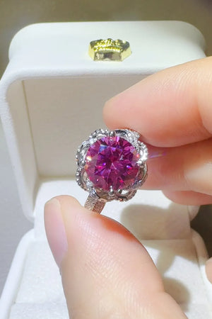 Crimson Bloom moissanite halo ring in cerise with intricate silver detailing.