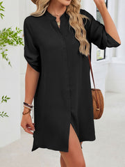 Black button-down shirt dress with band collar and rolled sleeves.
