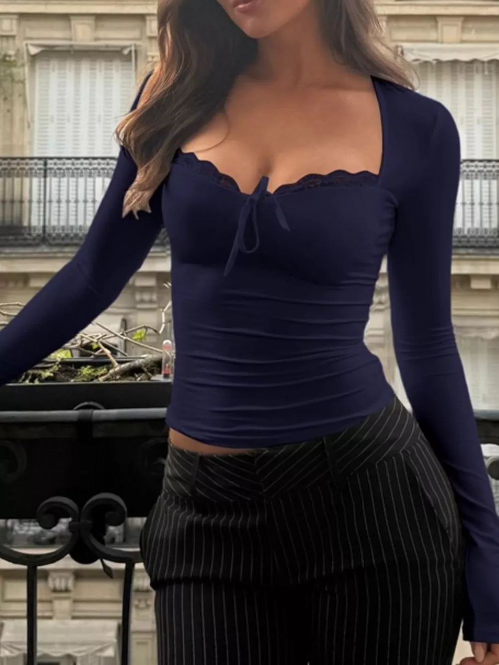 Navy blue long sleeve tee with lace trim and tie-front detail.