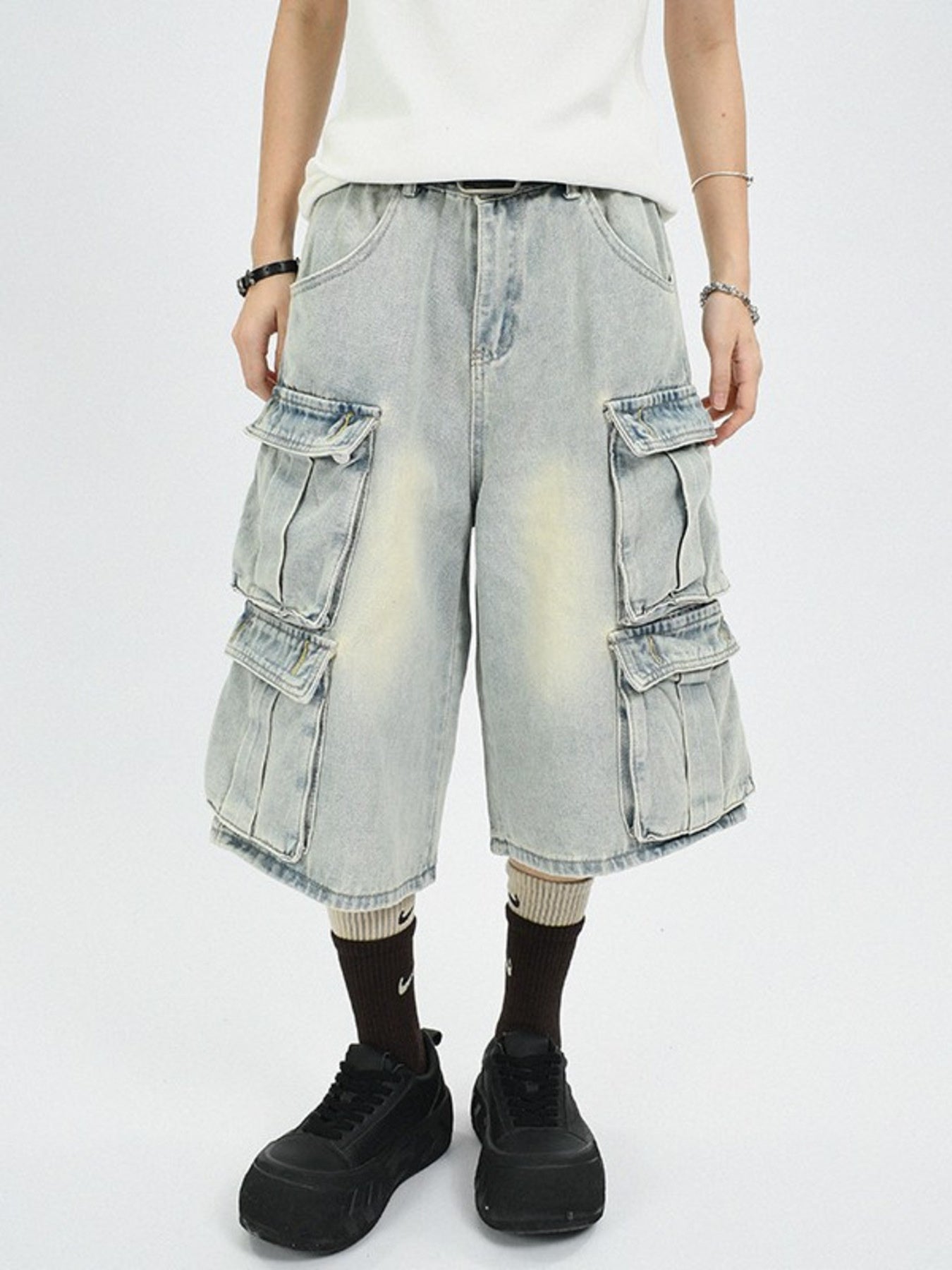 Men's light wash denim capri cargo pants with multiple pockets and a relaxed fit.