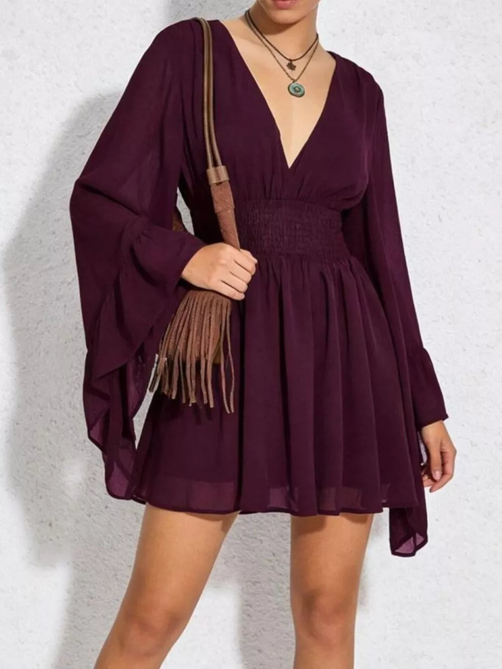 Burgundy A-line mini dress with plunging V-neck, bishop sleeves, and smocked waist.
