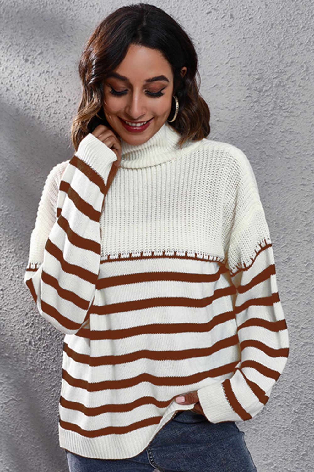 Turtleneck sweater with brown stripes and ribbed knit detail.