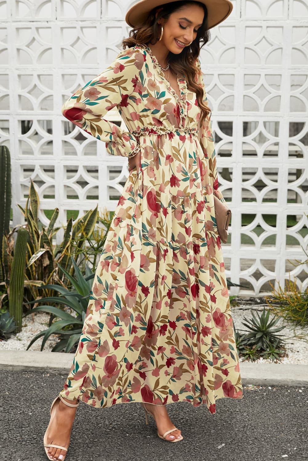 Floral ruffle maxi dress with tiered skirt in Floral print, V-neck, long sleeves, and cinched waist.