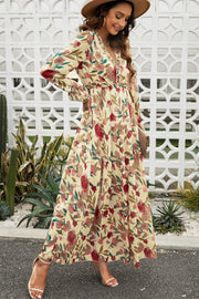 Floral ruffle maxi dress with tiered skirt in Floral print, V-neck, long sleeves, and cinched waist.