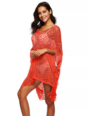 Orange crochet V-neck beach cover-up with intricate cutout pattern and fringe detail.