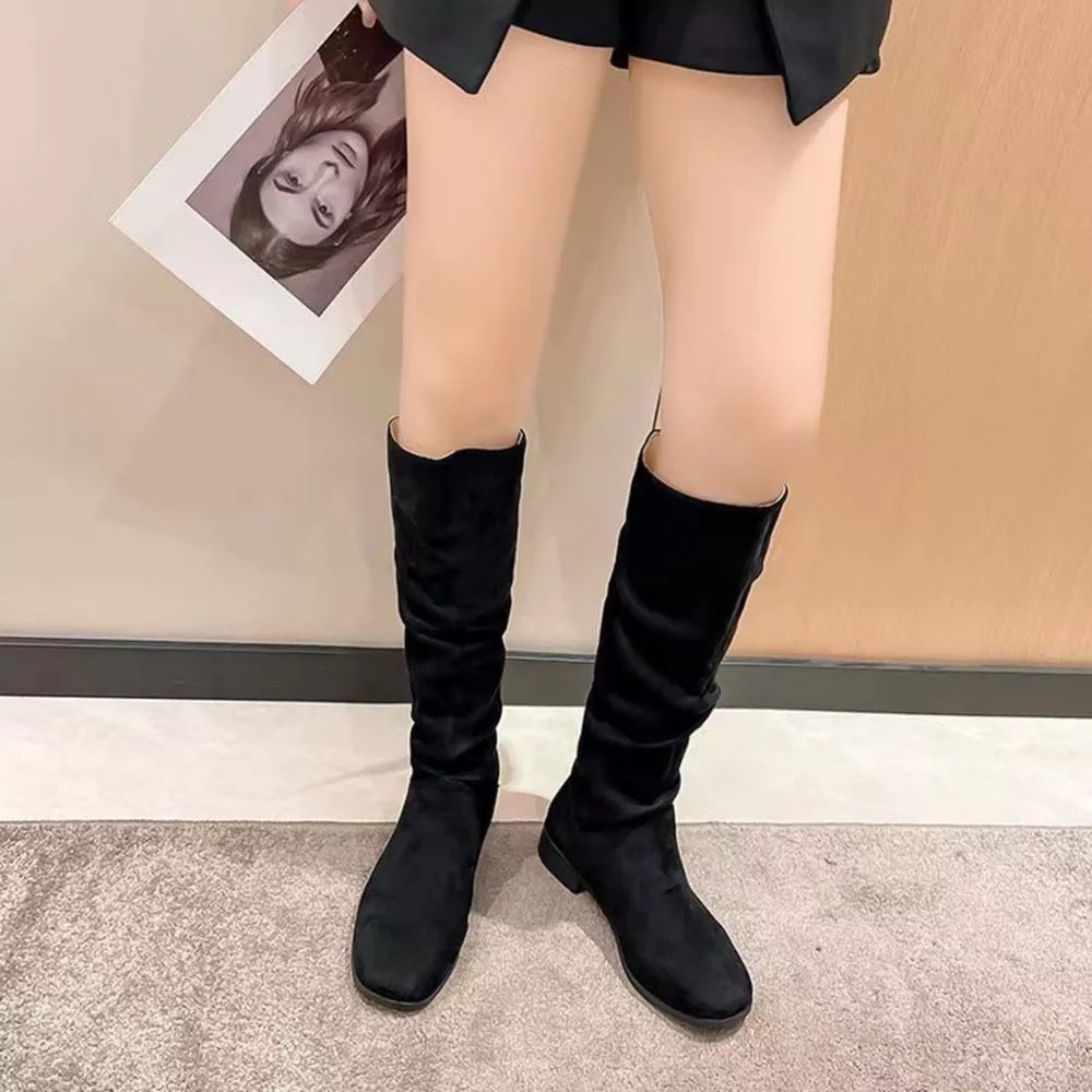 Black suede mid-calf boots with a slouchy shaft and block heel.