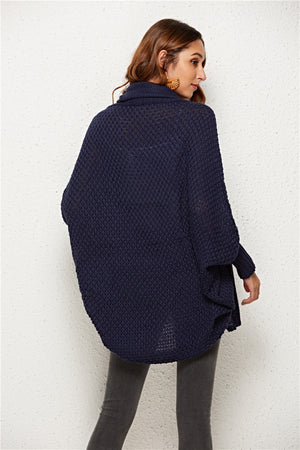 Textured cocoon knit cardigan in dark blue with batwing sleeves and a cowl neck.