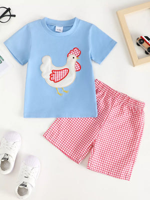 Baby blue t-shirt with chicken appliqué and pink gingham shorts.