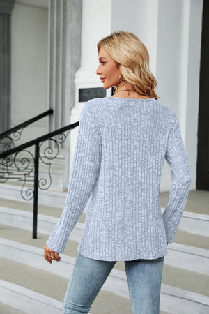 Light Blue ribbed tunic top with button detail and asymmetric hem, long sleeves.
