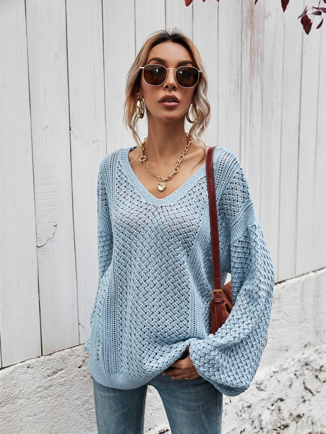Open-knit sweater in Misty Blue with V-neck and balloon sleeves.