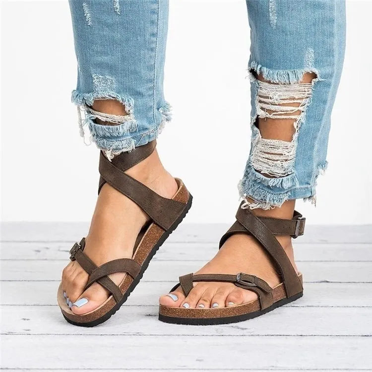 Brown crisscross strap cork footbed sandals with buckle ankle strap.