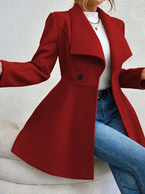 Rust draped collar flare-hem coat with a single button closure, styled with jeans.