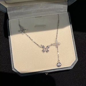 Elegant butterfly zircon necklace in silver sterling with a dangling charm.