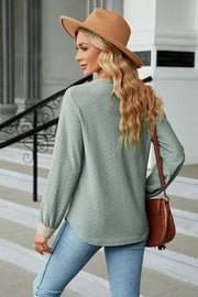 Sage green textured V-neck blouse with embroidered cuff detail