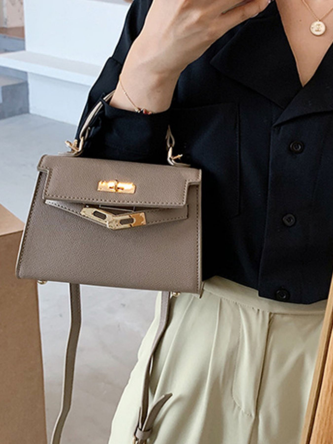 Premium mini crossbody bag in brown faux leather with gold hardware.