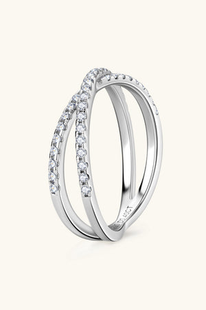 Silver pavé crossover band ring with two intertwined bands, detailed with small clear stones.