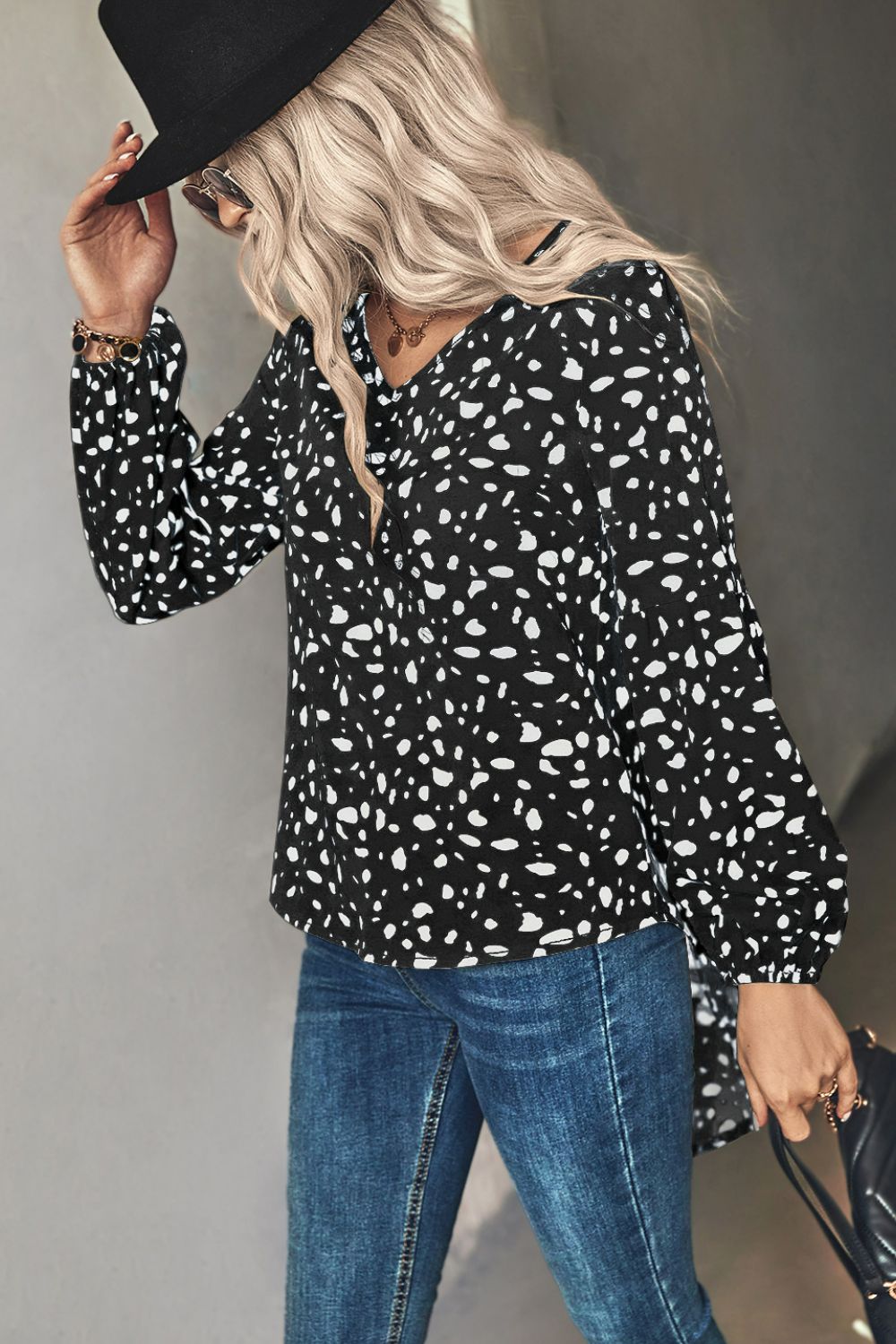 Black dalmatian print blouse with balloon sleeves and v-neck.