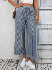 Navy blue and white striped wide leg pants with drawstring waist and pockets.