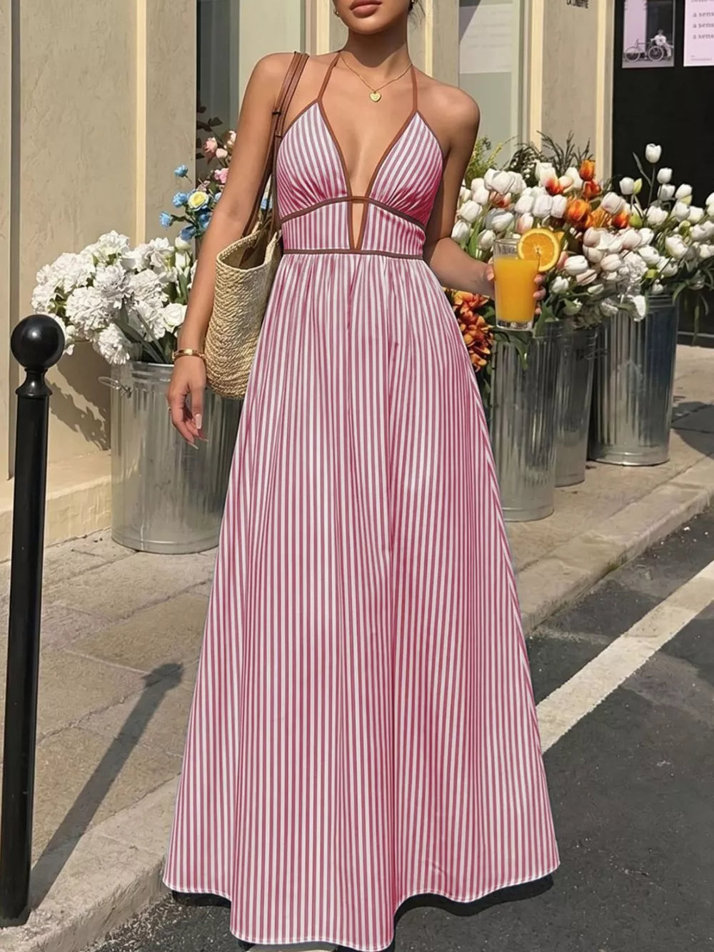 Burgundy striped halter maxi dress with plunging neckline and a-line skirt.