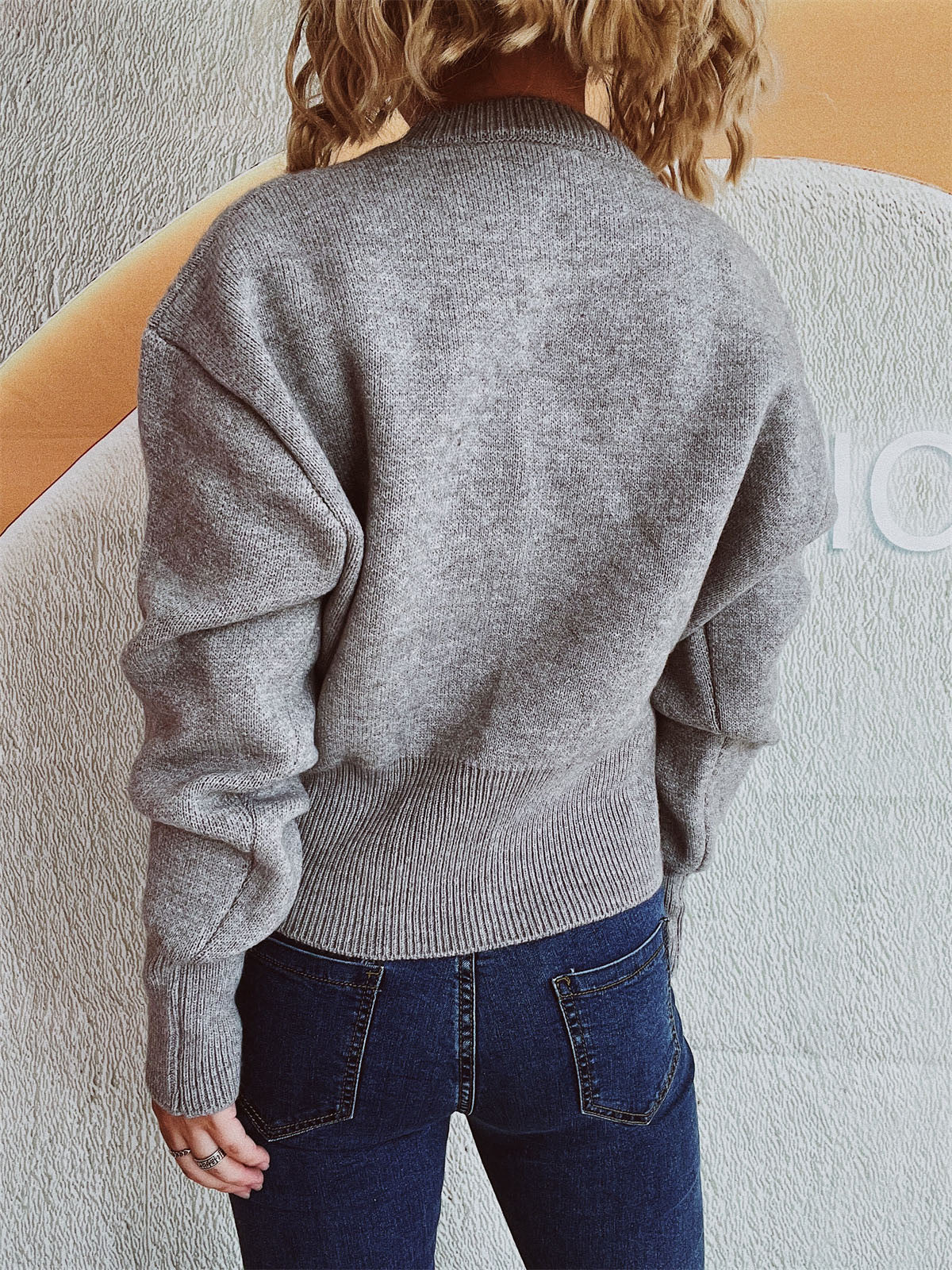Gray ribbed knit zip-front sweater with a mock neck and ribbed hem