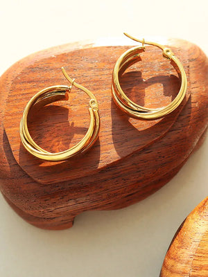 Gold double-band hoop earrings with a sculpted design.