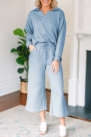 Light blue textured polo set with wide-leg culottes and a drawstring waist.