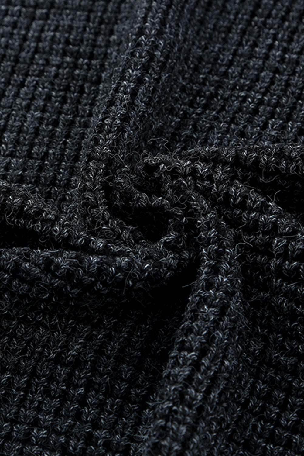 Textured black acrylic knit cardigan detail