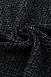 Textured black acrylic knit cardigan detail