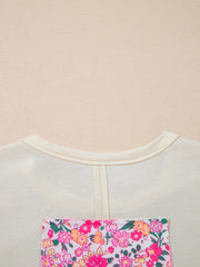 Cream cotton crew neck t-shirt with a colorful floral chenille patch pocket detail.
