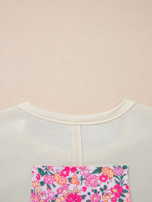 Cream cotton crew neck t-shirt with a colorful floral chenille patch pocket detail.
