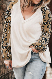 White waffle knit top with leopard print sleeves and V-neck