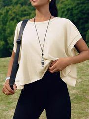 Apricot t-shirt with exposed seams and contrast stitching detail.