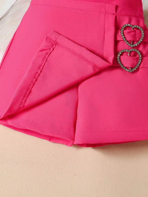 Toddler shorts in fuchsia pink with heart-shaped rhinestone buckle details.