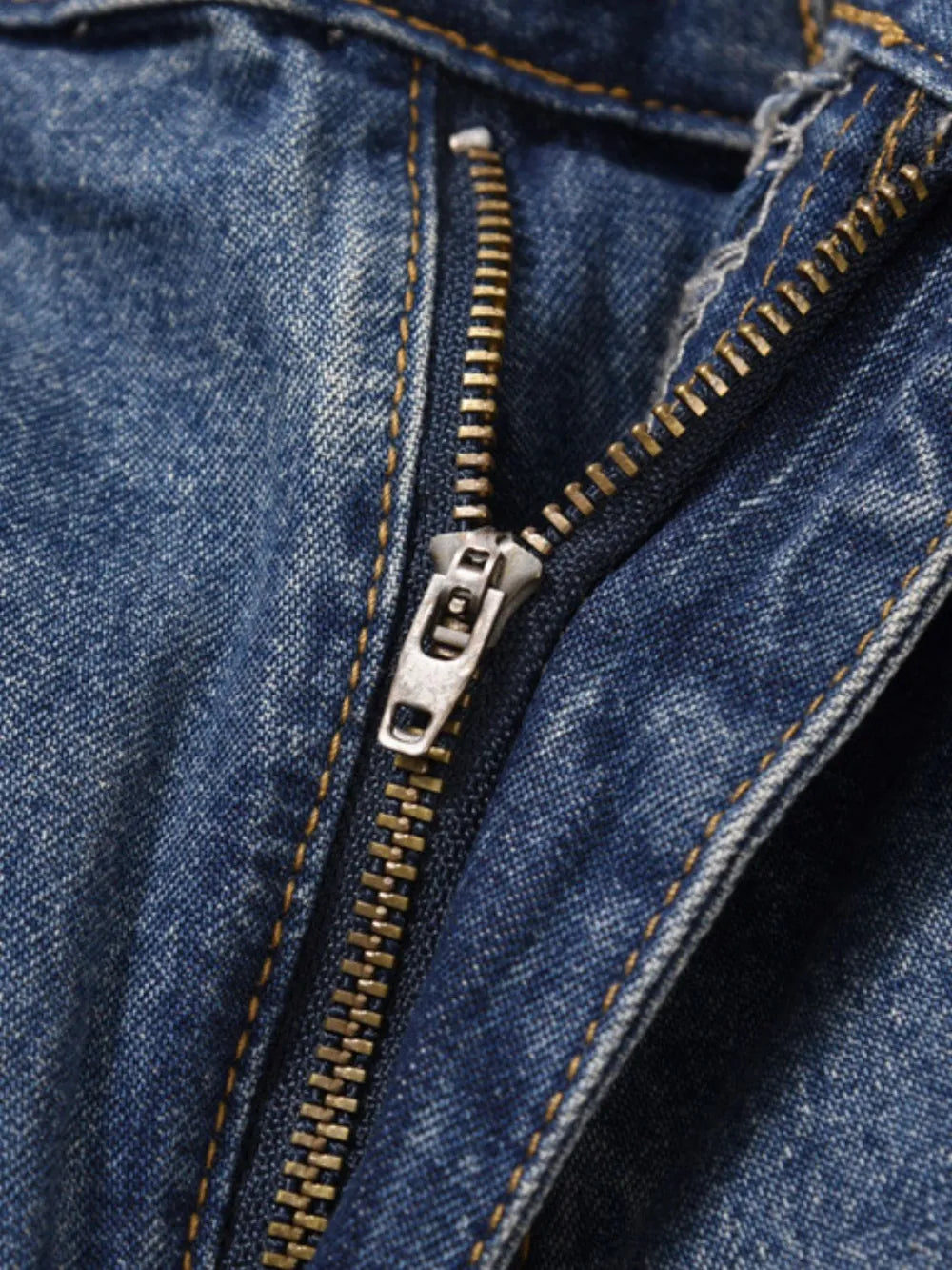 Carpenter denim bermuda shorts in medium wash with a metal zipper fly and contrast stitching.