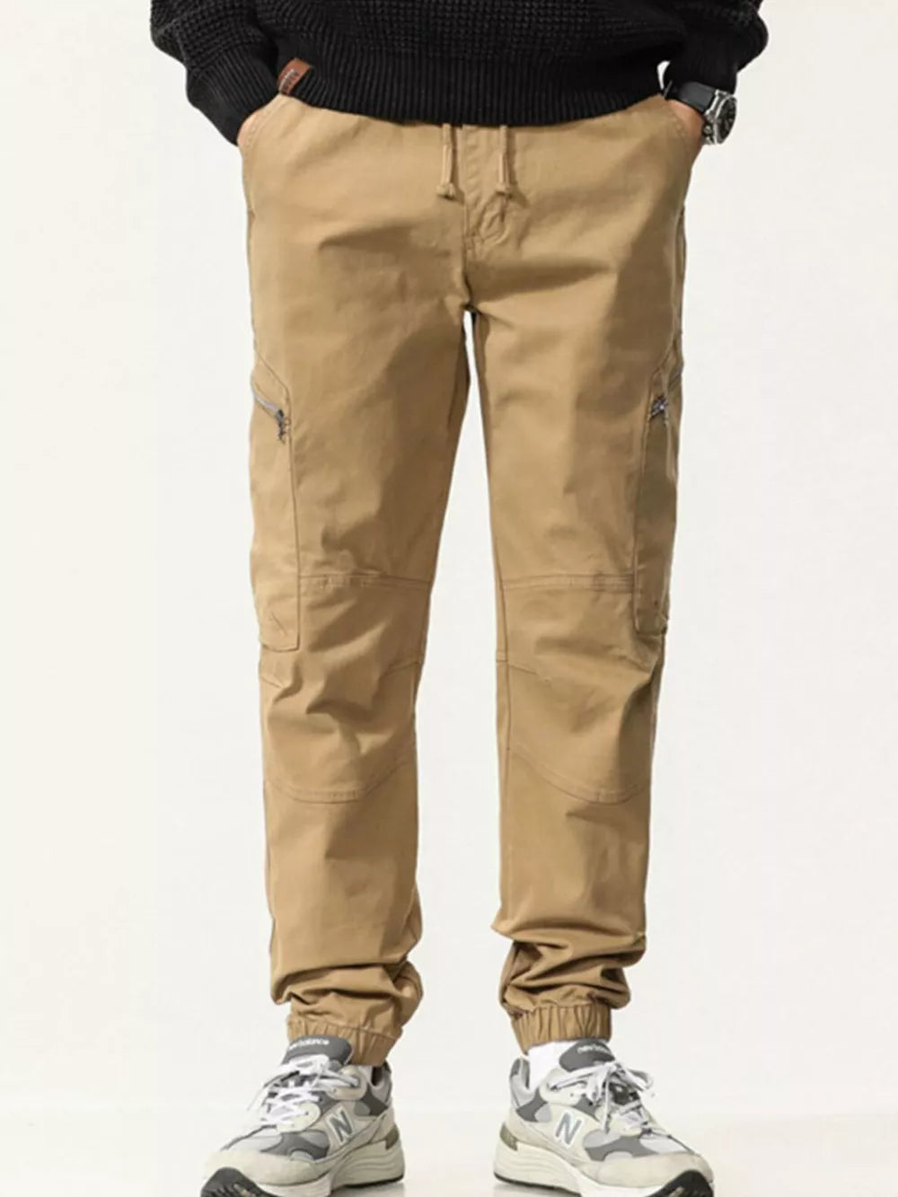 Men's Khaki cotton cargo pants with zippered pockets and drawstring waist.