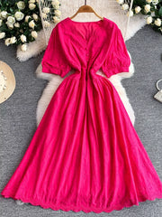 Pink lace-embellished A-line midi dress with V-neck, puff sleeves, and button front.