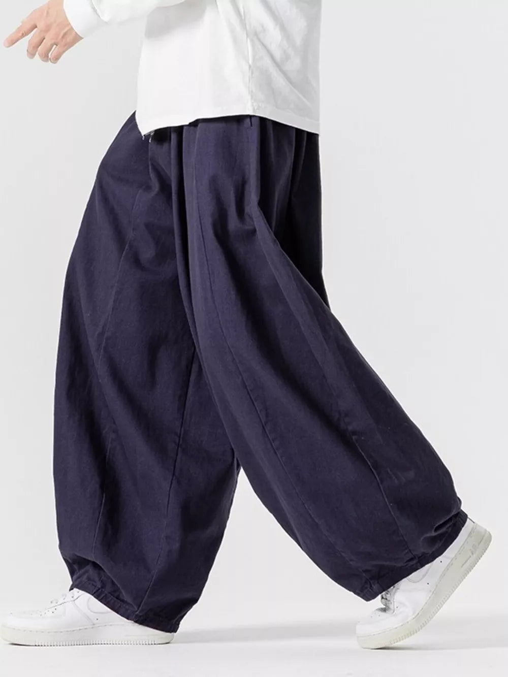 Navy relaxed fit drawstring sweatpants with baggy legs and cuffed ankles.